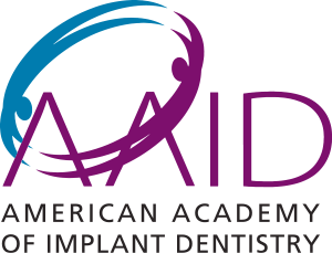 The image displays a logo with text, featuring a stylized graphic resembling a bird in flight with its wings outstretched, set against a background with a gradient of colors from blue at the top to purple and then to green at the bottom. The text on the logo reads AID in large white letters at the top, followed by AMERICAN ACADEMY OF IMPLANT DENTISTRY in smaller white letters below it. The style of the image is graphic with a modern design, commonly used for branding or as part of an organization s visual identity.